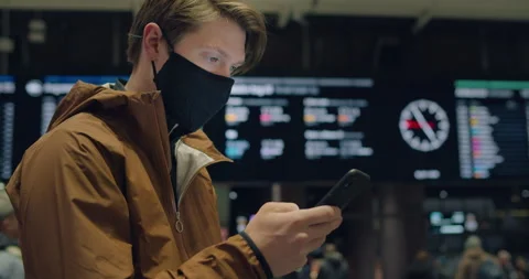 Young man at train station or airport in face mask Video stock 150263062