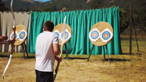 Young man training at archery with bow and arrows, people, sports Stock Footage 144212963