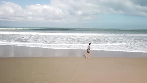 Young man training on the beach. Running on the shore. Stock Footage 159592832