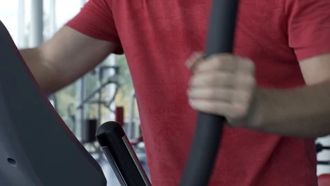 Young Man Training on Elliptical Machine in Gym Stock Footage 99864852