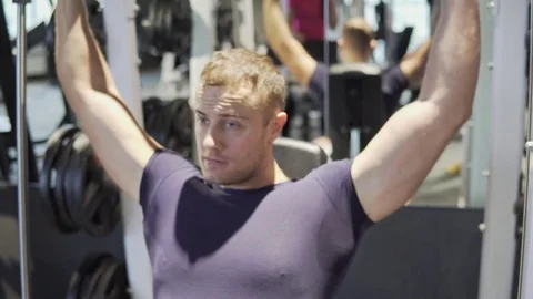 A young man is training in the gym. 4K Stock Footage 73779020