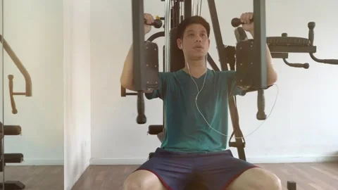 Young Man Training in Gym on Exercise Machine Stock Footage 315116159