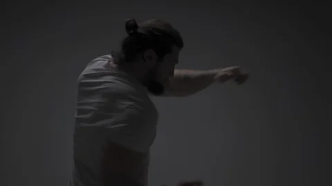 Young man training in half dark Stock Footage 126723522