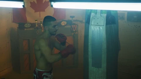 Young man training inside a boxing studio Stock Footage 100035063