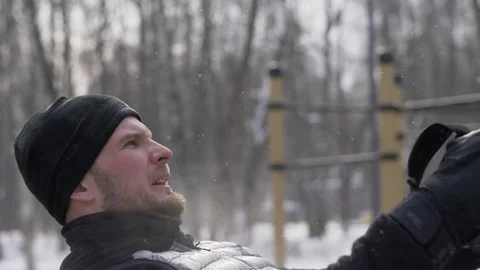 Young man training pull ups exercise with fitness straps on sport ground Stock Footage 87964038