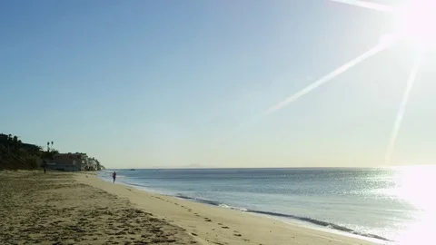 Young man is training at running on a beach Stock Footage 77706548