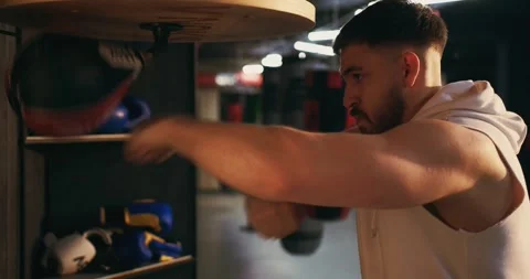 A young man is training with a speed bag in a boxing gym Stock Footage 275276302