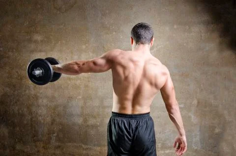 Young man training weights in od gym Stock Photos