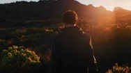 Young Man Trekking In Peaceful Countryside At Sunset Exploring Nature Stock Footage