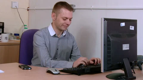 Young man tries to fix a problem on his computer Stock Footage 30445108