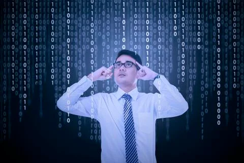 Young man try to solve binary code Stock Photos