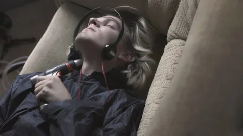 Young man is trying to commit suicide. Stock. Young man puts drill to his throat Stock-Footage 276320555