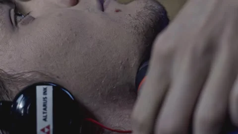 Young man is trying to commit suicide. Stock. Young man puts drill to his throat 库存影片 276922285