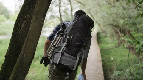 Young Man Trying to Keep the Balance on a Narrow Bridge Stock Footage 77675622