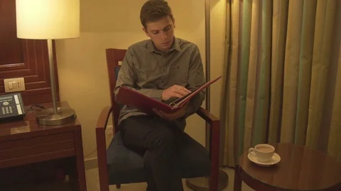 Young man trying to relax reading magazine Stock Footage 73986858