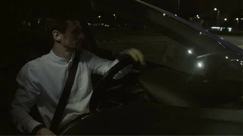 Young Man Turning the Steering Wheel and Driving Straight Stock Footage 78567773