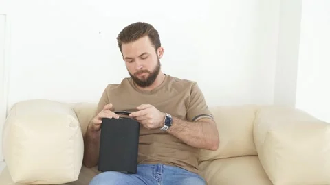 Young man turning on wireless smart column with the use of smartphone Stock Footage 156541319