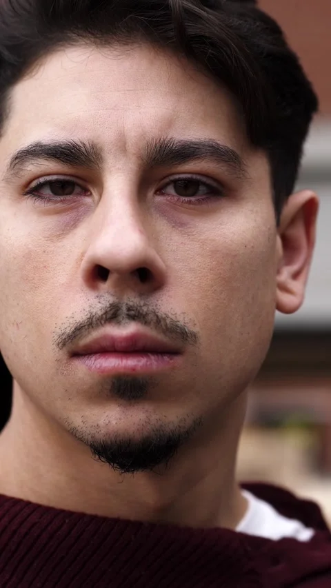 Young man turns to camera in extreme close-up with intense expression Stock Footage 306682226