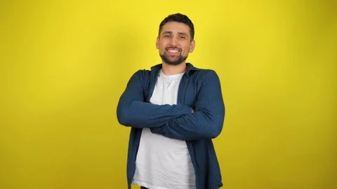 A young man is turns to camera, holding hands folded and smiles Stock Footage 119860150