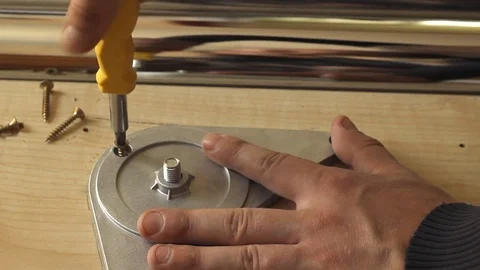 A young man twists screws with a screwdriver Video stock 79899540