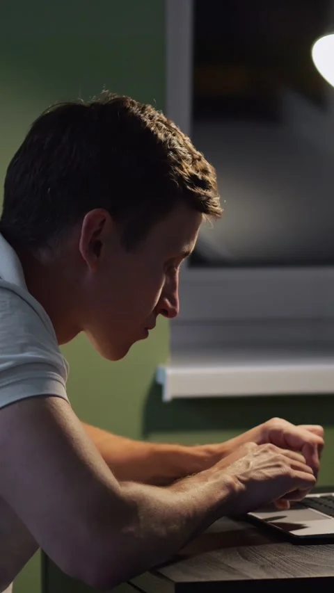 Young Man Types On Laptop Computer During Remote Computer Work At Night. Focused Stock-Footage 346989182