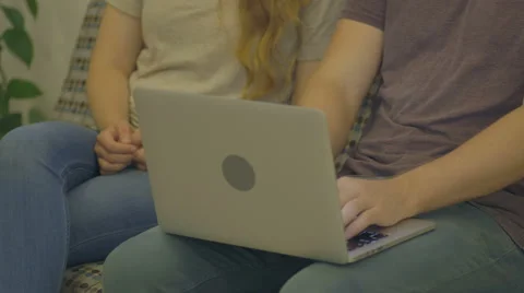 Young Man Types on Laptop with Young Lady by Him Stock Footage 60989347