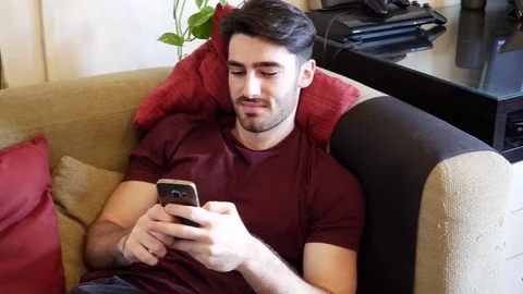 Young man typing and using cell phone Stock Footage 79571698