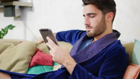 Young man typing and using cell phone Stock Photos