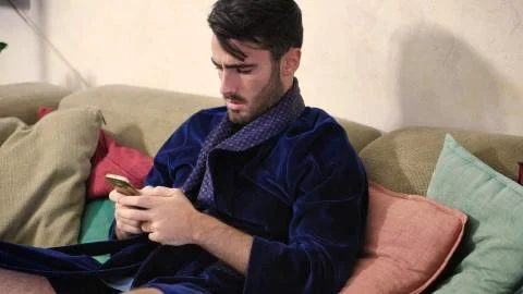 Young man typing and using cell phone Stock Photos