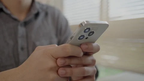 Young man typing chat/message on mobile phone with smiling face, Digital Comm Stock Footage 251194013