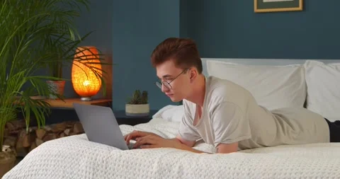 Young man typing chatting on lwith friends or girlfriend typing on a laptop Stock Footage 142478699