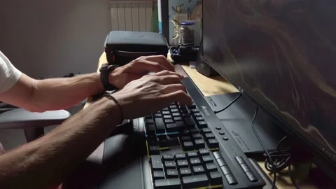 Young Man Typing Keyboard in Front of Computer at Home Stock Footage 131439272