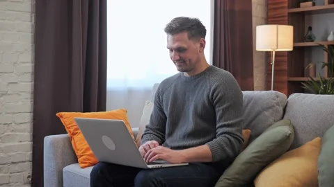 Young man is typing on laptop computer messaging businessman working at home. Stock-Footage 172394265