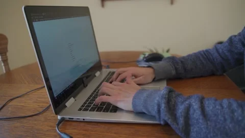 Young man typing in a laptop 스톡 동영상 132351003