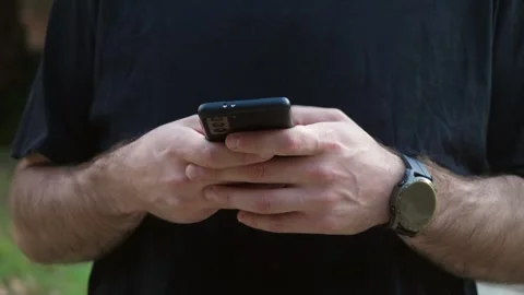 Young man typing a message on his smartphone Stock Footage 289002949