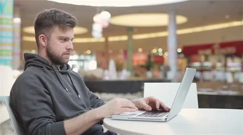 Young Man Typing a Message on a Laptop and Laughing. Stock Footage 47977506