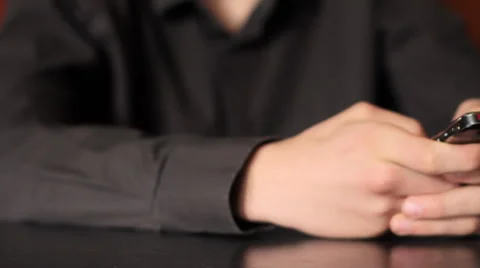 Young man typing on mobile phone. Shot with slider shot. Stock Footage