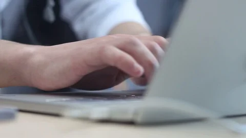 Young man is typing on a modern laptop in the office Stock Footage 87136251