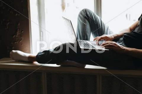 Young man typing something on a laptop Stock Photos