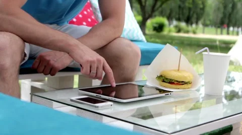 Young man typing on the tablet in nature Stock Footage 65155745