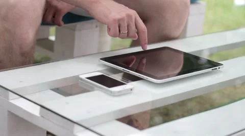 Young man typing on the tablet in nature Stock-Footage 65155756