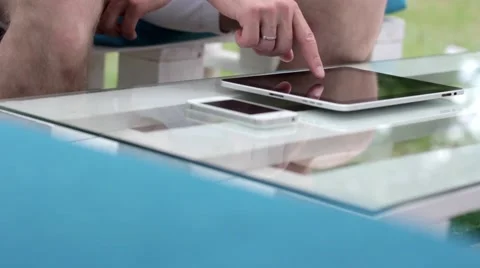 Young man typing on the tablet in nature Stock-Footage 65155764