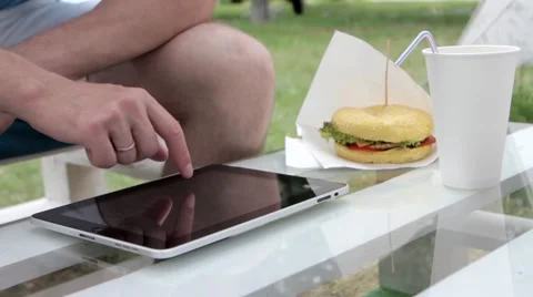 Young man typing on the tablet in nature Stock-Footage 65155775