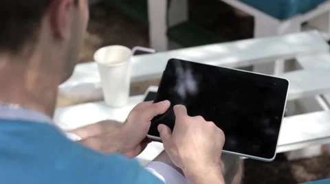 Young man typing on the tablet in nature Stock-Footage 65156276