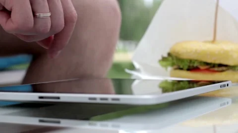 Young man typing on the tablet in nature Stock Footage 65156279