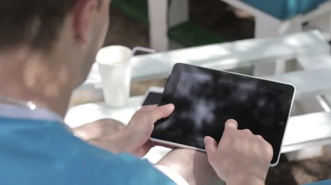 Young man typing on the tablet in nature Stock-Footage 65156291