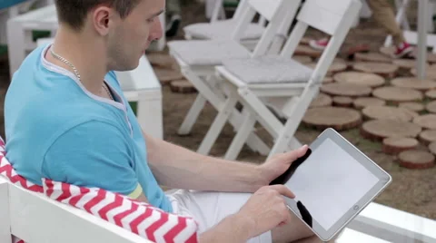 Young man typing on the tablet in nature Stock-Footage 65156307