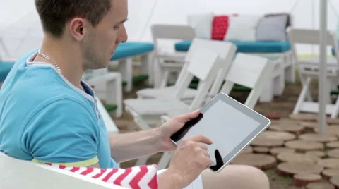 Young Man Typing on the Tablet in Nature Stock-Footage 65156431