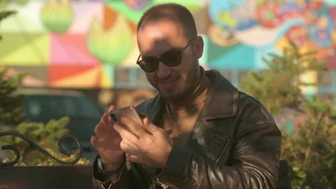 Young man typing text on a smartphone phone outdoor in the city street Stock-Footage 161084007