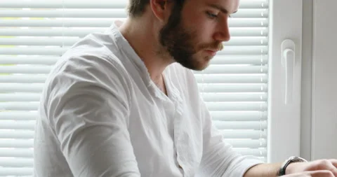 Young man typing thinking and then dreaming Stock Footage 142216757